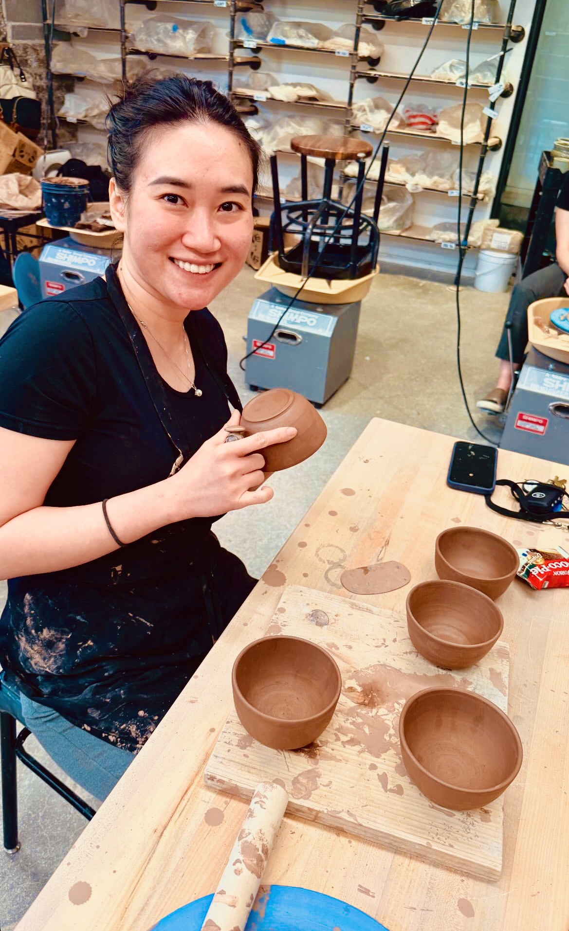 Photo of Nhi working on her pottery